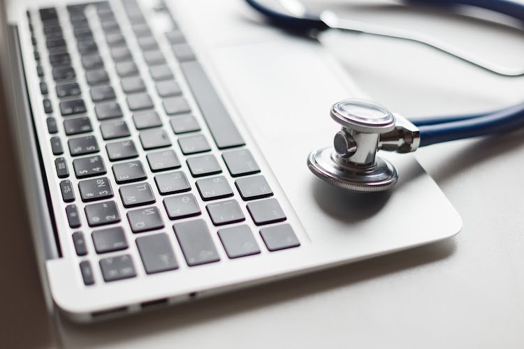 Virtual doctor. Computer and stethoscope. Soft focus
