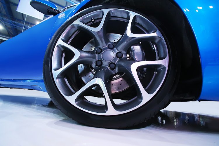 wheel of new blue sports car close up