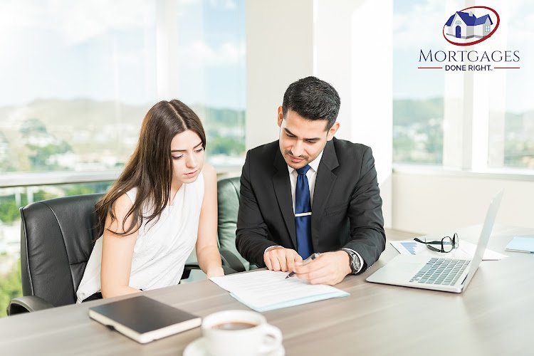 Young adviser explaining legal document to client in his office